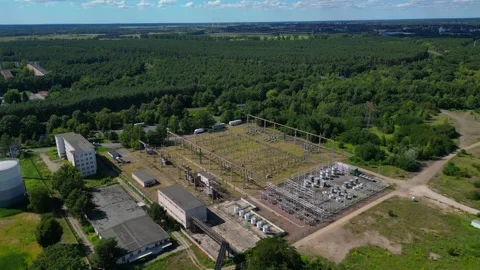 Substation distributing electricity at forest. Dramatic aerial view flight drone Vídeo Stock 315474325