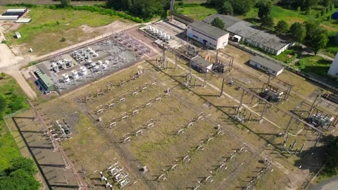 Substation distributing electricity at forest. Magic aerial view flight drone Vídeo Stock 315474291