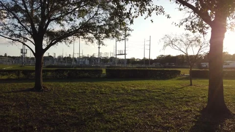 SubStation Electric pan left to right daytime trees in foreground Stock Footage 227343638