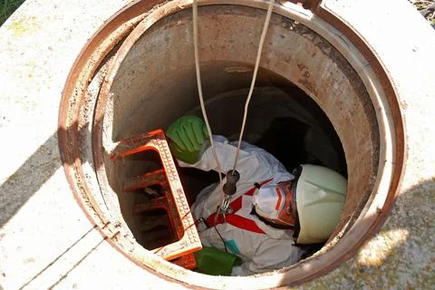A subsurface technician inspects a sewer, to inspect the city's waste water Stock Photos