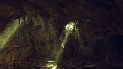 Subterranean scene with contrasting shadows and textured stone features Stock Footage 340664876