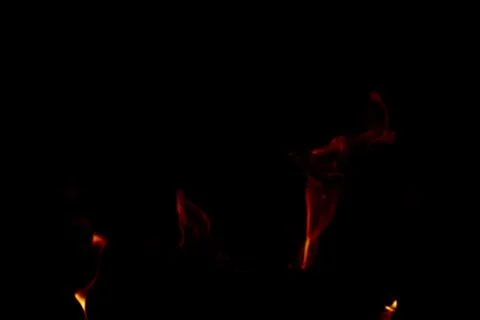 Subtle background of orange flames on black backdrop with copy space Stock Photos