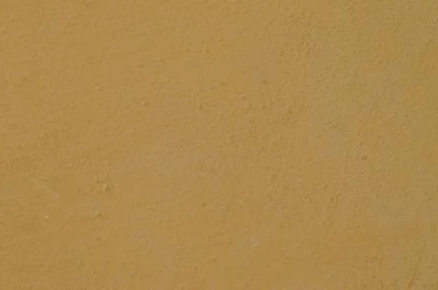 A subtle, beige textured plastered wall background Stock Photos