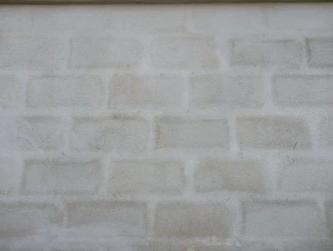 Subtle block pattern showing through light grey plastered wall, minimalist .. Stock Photos