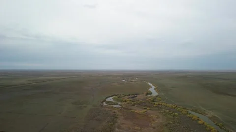 Subtle drone drift over winding river in Kazakh steppe Stock Footage 334325901