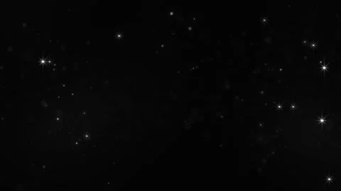 Subtle glowing stars and soft floating dust on a deep black background, creat Stock Footage 328707488