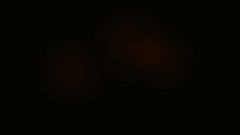 A subtle gradient of deep crimson light emerging from the pitch black darknes Stock Footage 338311260