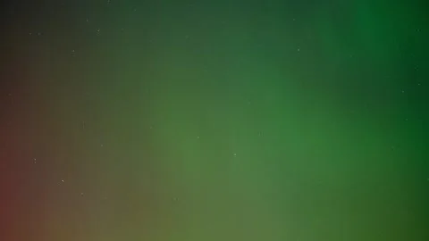 Subtle green Aurora pulse in a starry sky with hints of red colors Stock Footage 287958599