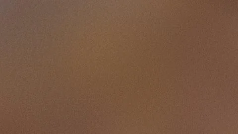 Subtle noise effect on a grainy brown gradient background 스톡 사진