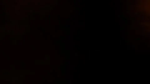 Subtle orange ember fog drifting on black background Видео 330981734