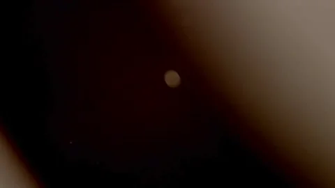 Subtle orange light leaks dance over floating dust particles Stock Footage 329598469