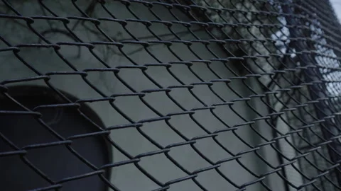 Subtle Panning Shot of Chain-Link Wire Fence - Urban Security Detail Stock Footage 326697940