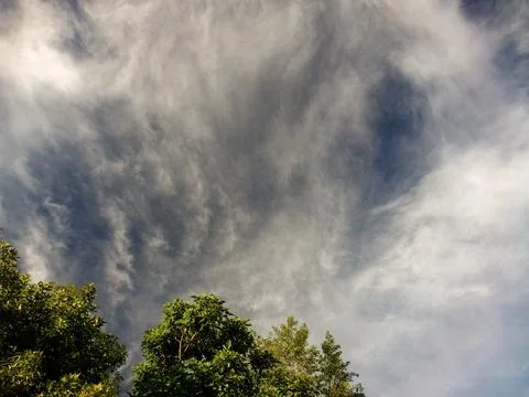 Subtle soft clouds floating over a farm before sunset, in the eastern Andean  Stock Photos