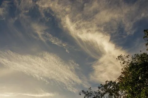 Subtle soft clouds floating over a farm before sunset, in the eastern Andean  Stock Photos