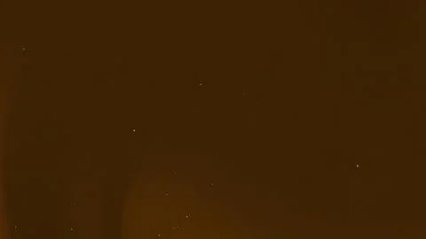 Subtle specks of light against a rich brown background. Stock Photos