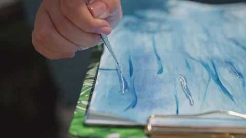Subtle strokes depict calming aquatic scenes. Focused artist employs beaded Stock Footage 346544490