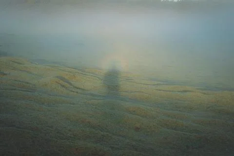 Subtle underwater light casts a long shadow over a sand-covered lakebed or .. Stock Photos