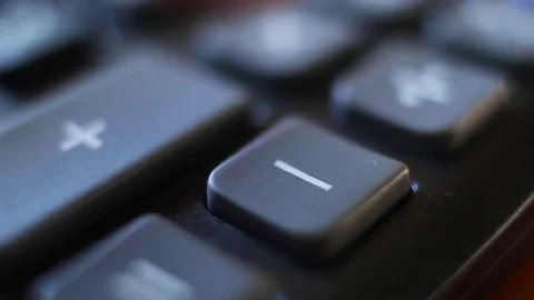 Subtraction on a calculator device. Finger press on minus button calculator Stock Footage 75964622
