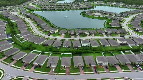 Suburban community with central lake in Florida. Rows of single-family Stock Footage 281765341