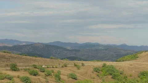 Suburban highway through hilly terrain Stock Footage 79450136