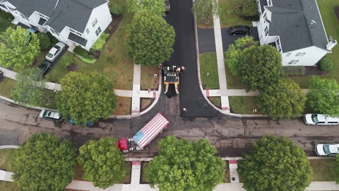 Suburban roadwork development new asphalt road and real estate houses. Aerial Stock Footage 296086618
