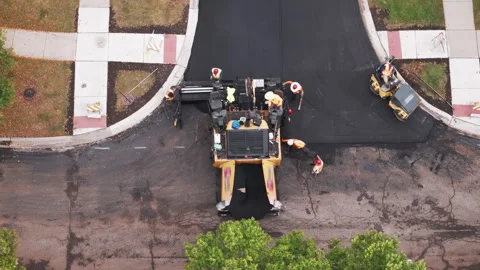 Suburban roadwork development new asphalt road and real estate houses. Aerial Stock Footage 296086633