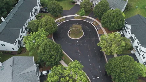 Suburban roadwork development new asphalt road and real estate houses. Aerial Stock Footage 296086651
