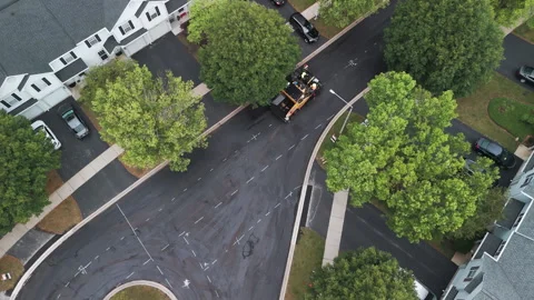 Suburban roadwork development new asphalt road and real estate houses. Aerial Stock Footage 296086690