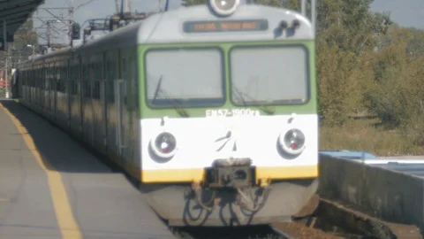 A suburban train departs from the platform Stock Footage 107676950