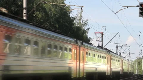 Suburban Train is moving forward on the rails to the side of the camera. Stock-Footage 40905252