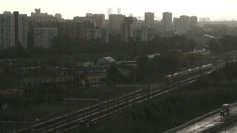 Suburban train moving through the city during heavy rain. Stock Footage 80633685