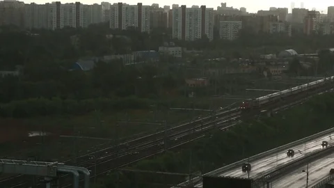 Suburban train moving through the city during heavy rain. Stock Footage 80633828