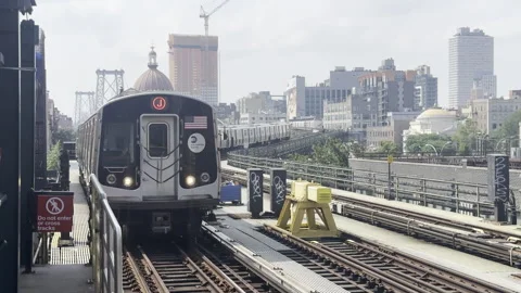 Subway on a bridge in nyc getting to the station daylight Stock Footage 257343539