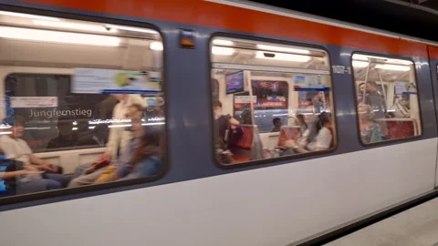 Subway car windows show passengers arriving to station in Hamburg city Germany Stock Footage 313345217