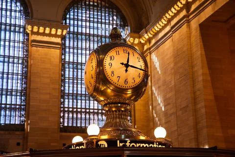 Subway clock golden light inside iconic Grand Central Station New York City Stock Photos