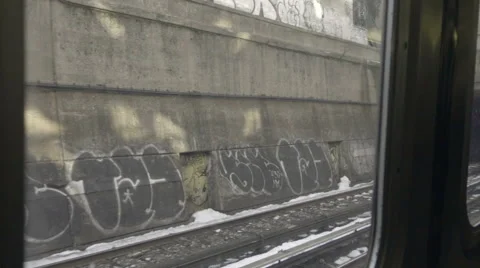 Subway entering tunnel - window view of graffiti riding on B train in winter NYC Stock Footage