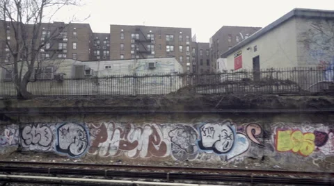 Subway graffiti wall poverty stricken ghetto neighborhood Brooklyn NYC Stock Footage