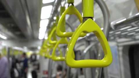 Subway hand straps swaying inside a moving train Stock Footage 332644004