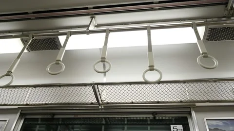 Subway handle at train, white rings hang down and sway during car ride Vidéo 137469546