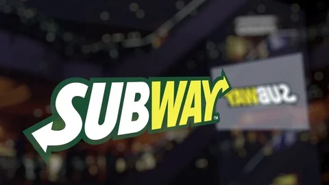 Subway logo on the glass against blurred business center. Editorial 3D rendering Stock Footage