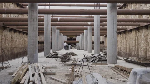 Subway platform festooned with columns supporting future ceiling Stock Footage 296713193