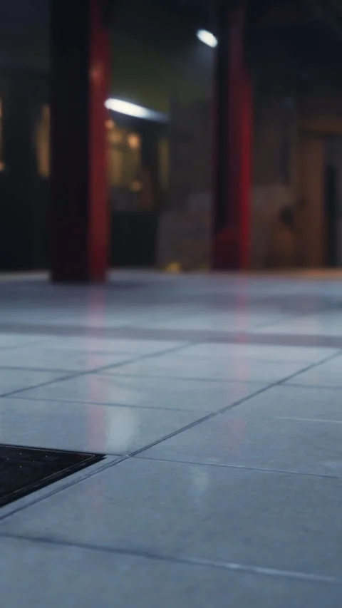 Subway platform view showing empty tiles and train in background Stock Footage 337947957