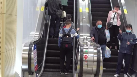 Subway rush hour people shuttle up and down the elevator Stock Footage 154498809