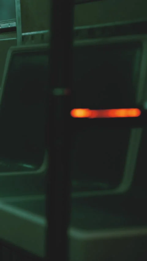 Subway scene showing empty seats and a glowing handle at night Vidéo 338346944
