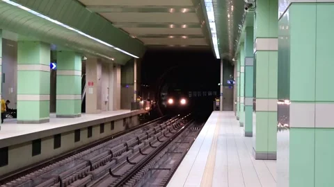 Subway station platform with train approaching from a dark tunnel Video stock 297610961