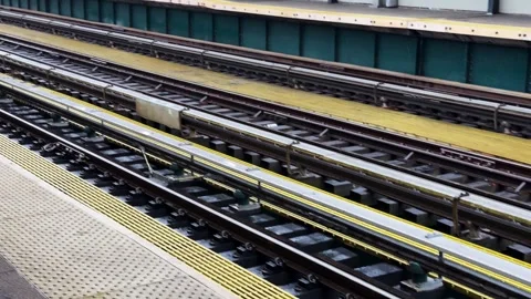Subway Train Arrives at Elevated Outdoor Platform in Bushwick, New York City Stock Footage 348331176
