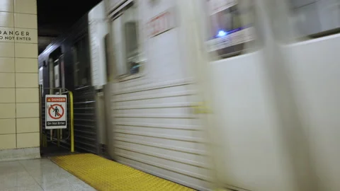 A subway train arrives at the platform of an underground station Stock Footage 238424797