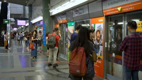 Subway Train Arriving and Commuters Entering at MRT Station in Singapore Video stock 114646768