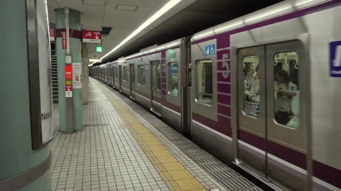 Subway train arriving and commuters exiting at metro station in Osaka, Japan Stock Footage 264171556