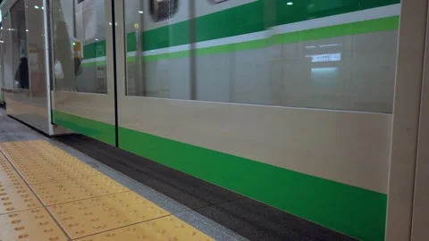 Subway train commuter while arriving to the platform of tokyo subway metro Stock Footage 153477800